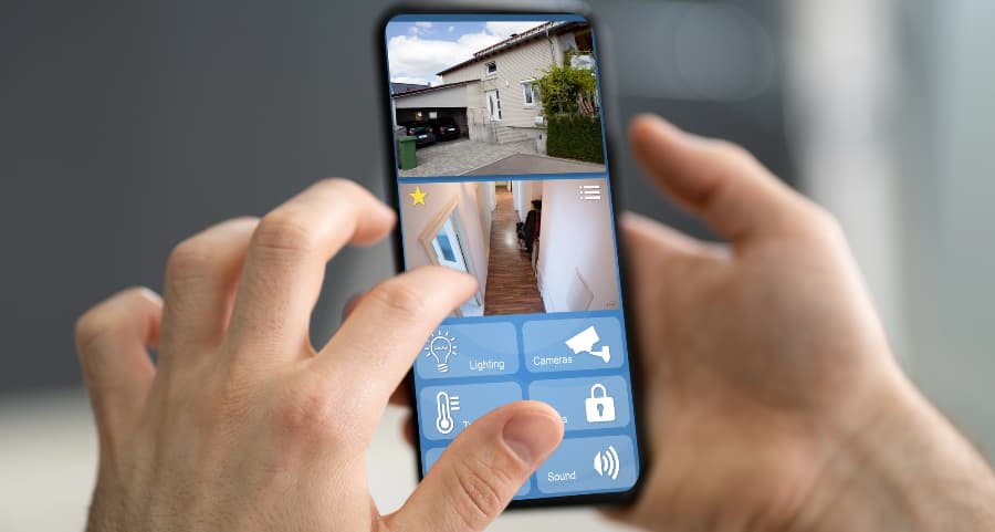Homeowner looking at surveillance camera feeds on a smartphone