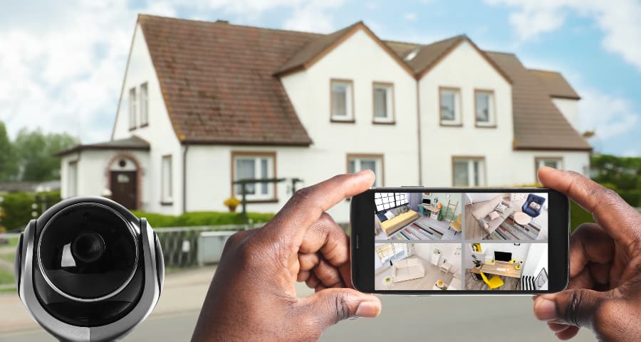 Man holding phone and checking footage from video cameras
